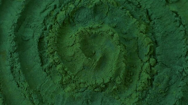 Chlorella or spirulina algae green powder circle rotation close up. Dietary supplement to improve health. Seaweed superfood. Healthy food background. Vitamins and minerals to diet detox