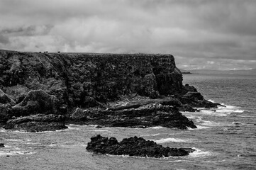 A rocky cliff overlooks the ocean