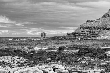A rocky shoreline with a small rock on it