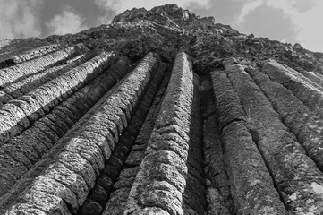 The image is a black and white photo of a mountain with a lot of ridges