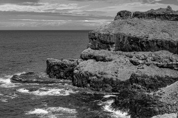 A rocky cliff overlooks the ocean