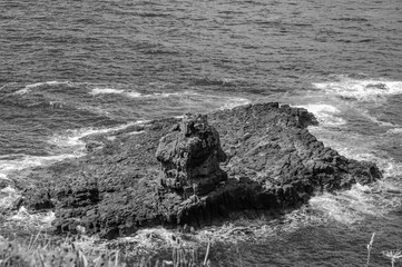 A rocky outcropping sits on the edge of the ocean