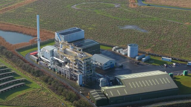 Modern bioenergy facility in Boston Lincolnshire captured by drone featuring fuel storage and stacks for sustainable green electricity generation