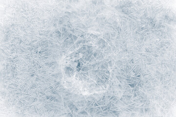 Crystalized ice background texture with cracks in a web-style in a light-blue tone.