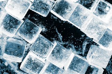 Ice cubes crush on a black background. Chill backdrop. Frame border, made of ice.
