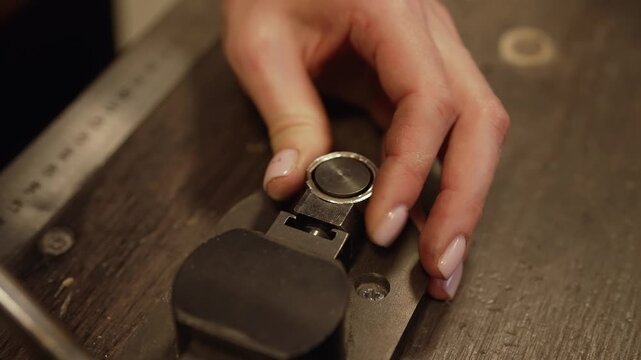 Jewelers hand using professional ring bender.
