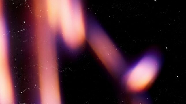 Abstract streaks of pink, purple, and orange light create a vibrant film light leak texture.