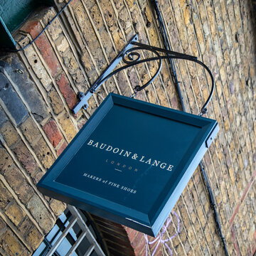 LONDON, UK - JULY 28, 2019: Sign outside the HQ of Baudoin & Lange Shoemaker in Ezra Street, East London