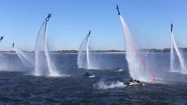 Flyboard show on the river at the city holiday. Performing different tricks in hydrofly. Hydro flight device