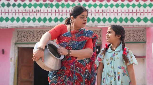 Happy indian farmer daughter with mother 