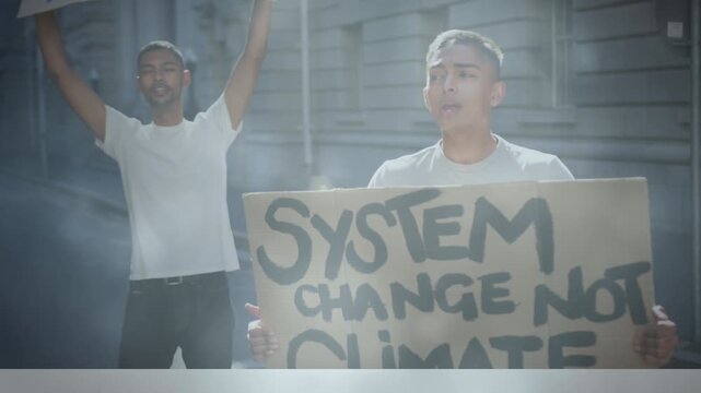 Diverse group of angry activists holding cardboard banners while giving slogans in protest march