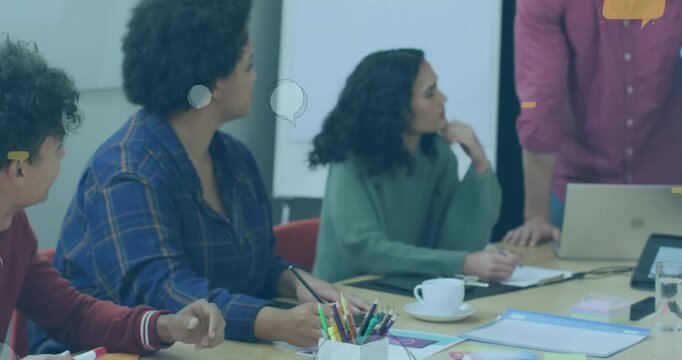 A diverse group of happy businesspeople discussing work during a meeting at a modern office