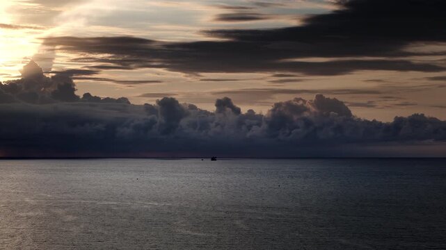 Dramatic sunset over Luanda Bay with industrial sand dredging channels and birds, Angola