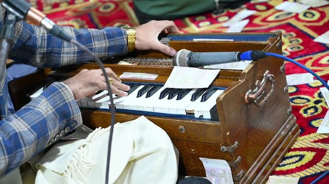 Close up of a hand playing indian classical music instrument harmonium 4k video