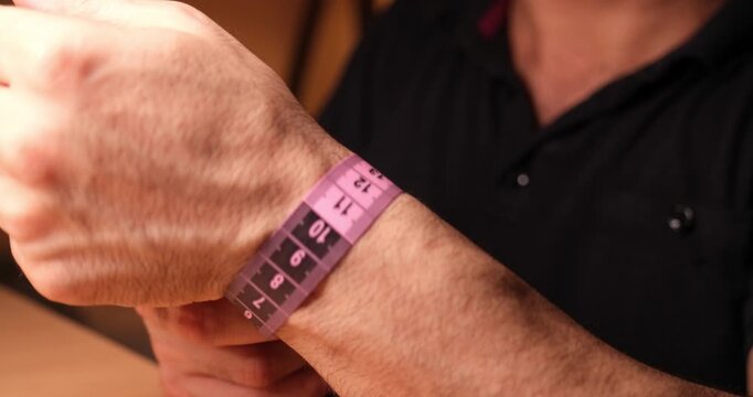 Man Measuring Wrist Circumference with Measuring Tape, Body Measurement and Health Concept