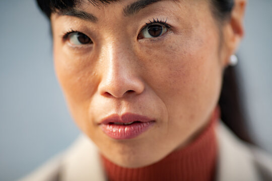 Close-up portrait of a confident woman indoors