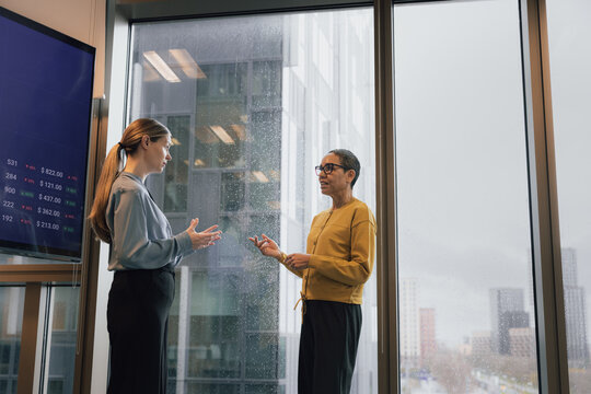 Female traders discussing the Market on a grey day