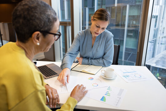 Businesswomen analysing data together in a meeting