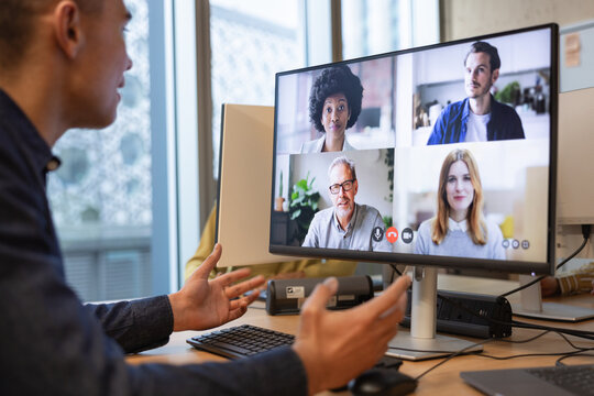 Businessman on a video call in an open plan office