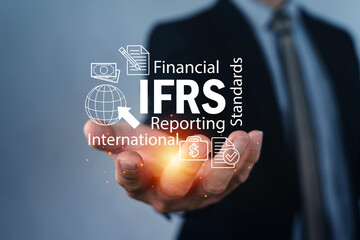 IFRS international financial reporting standards concept with businessman hand and icons