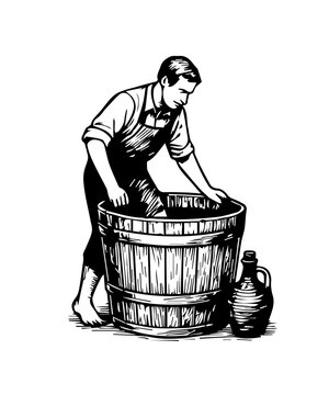 Winemaker crushing grapes for wine production in barrel