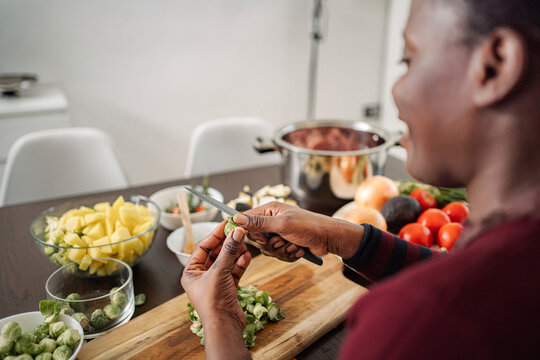 Woman peeling brussels sprouts for healthy meal prep