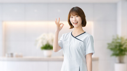 Fototapeta premium 美容サロンでOKサインをする笑顔の女性スタッフ,清潔感のあるエステイメージ, Smiling Female Staff Showing OK Sign at a Beauty Salon with Clean Interior