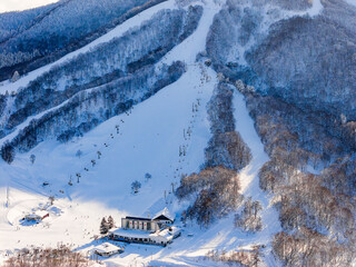 Aerial view of Madarao Mountain Resort in Nagano showing snowy slopes, lifts, and lodge