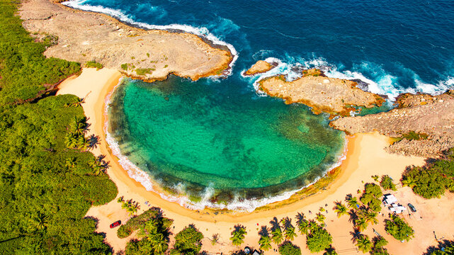 Tropical cove beach in Puerto Rico. Aerial view of a secluded tropical cove with turquoise water and sandy beach in Puerto Rico.