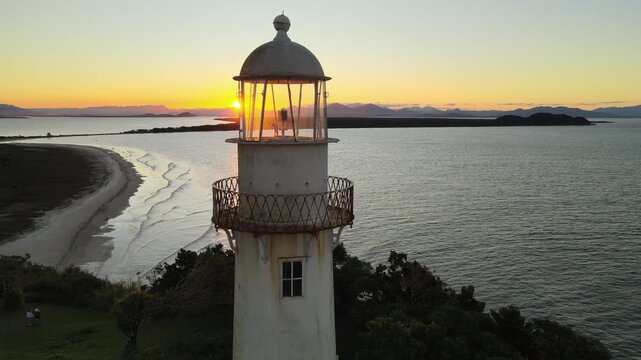 Voo sobre Farol da Conchas na Ilha do Mel no litoral do Paran&aacute; em Paranagu&aacute; ao entardecer p&ocirc;r-do-sol durante da golden hour com c&eacute;u limpo