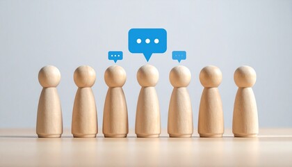 Row of Miniature Wooden Figures with Blue Chat Speech Bubbles for Team Communication, Social Networking, and Public Opinion Concept