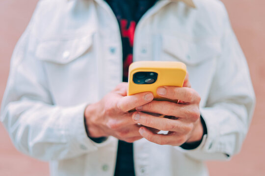 using mobile phone holding cell phone texting message contact us.chatting,search internet shopping online.device communication connecting