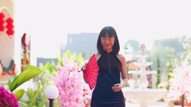 A beautiful Asian woman wearing a red cheongsam during Chinese New Year.