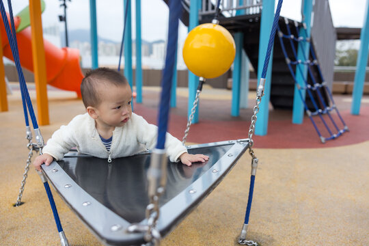 Happy baby playing at colorful kid park
