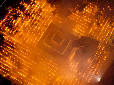 Aerial view of a maze of warm, glowing lights illuminate the ground, creating a mesmerizing pattern against the dark night sky, Baradi, Dhaka, Bangladesh.