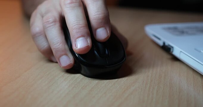 Hand Using Mouse While Working on Laptop, Close-Up of Computer Workspace