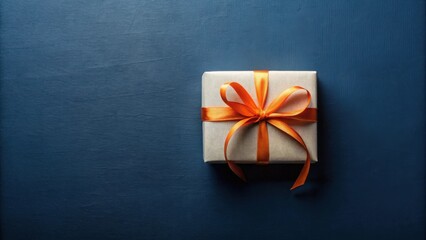 A single, elegantly wrapped gift box with a vibrant orange ribbon, resting on a deep blue background, perfect for celebratory occasions or conveying a sense of anticipation