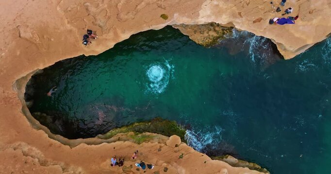 Aerial view St Peter's Pool in Malta. A famous beach in Malta for adrenaline junkies and diving into crystal clear waters, popular among tourists and young people