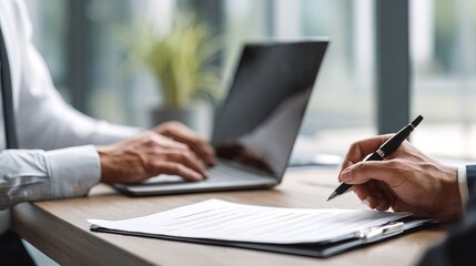 Fototapeta premium Professional hr manager engaged in typing notes on laptop in modern office setting with natural light focus on productivity and efficiency