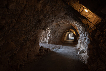 Obraz premium A rugged underground tunnel carved from stone