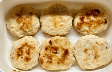 Fototapeta premium Fried Meat Patties. Homestyle Fried Meat Served On Tray. Meal Featuring Homemade Fried Meat In White Dish. Rustic Homemade Meat Cutlets With Golden Crust Prepared For Family Lunch