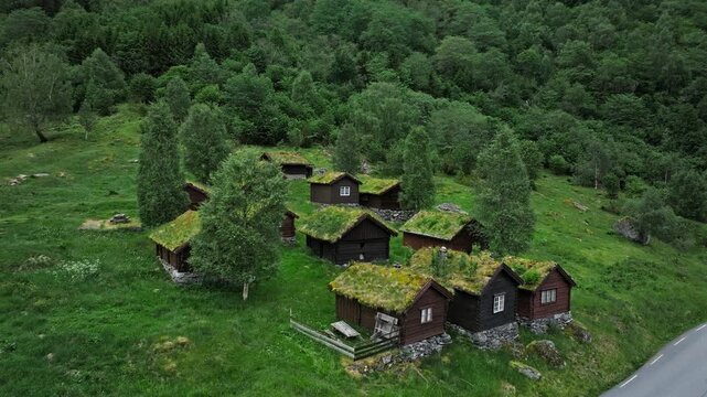 Aerial view of Breng Seter historic summer farm in Loen Valley, Norway. Grass-roofed cabins and trees convey rural heritage and quiet summer life.