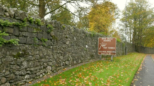 A road sign along highway N21 towards Main Street entering Adare, County Limerick, an historic heritage designated town in the Republic of Ireland.