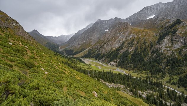 Green mountain valley with river and steep mountain peaks, Chong Kyzyl Suu Valley, Terskey Ala Too, Tien-Shan Mountains, Kyrgyzstan