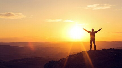 Fototapeta premium silhouette of man on mountain peak with arms raised against golden sunrise. concept of success, freedom, and achievement. website header, banner, social media post, copyspace.
