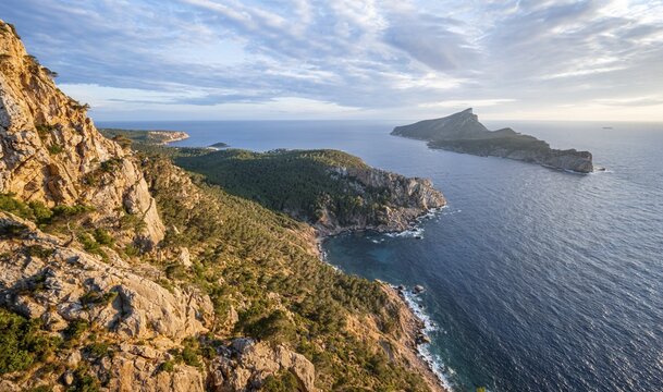 View of mountains and coast with sea, in the evening light, hiking to La Trapa from Sant Elm, at the back island Sa Dragonera, Serra de Tramuntana, Majorca, Spain