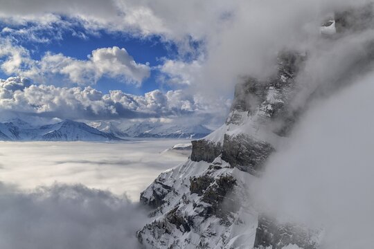 Fog with storm clouds over the Rhone valley, blue sky, Gemmi, Valais, Switzerland