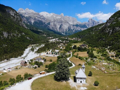 Theth village church. Summer landscape of Theth Mountains in Albanian Alps (also known as Accursed Mountains). Alps of Albania National Park.