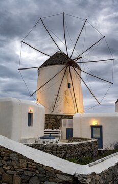 Illuminated windmills, Kato Milli, at sunset, dramatic cloudy sky, Mykonos Town, Mykonos, Greece