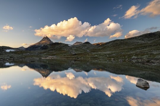 Mountain landscape in Jotunheimen National Park, Raudehaugen, reflection in small mountain lake, Norway